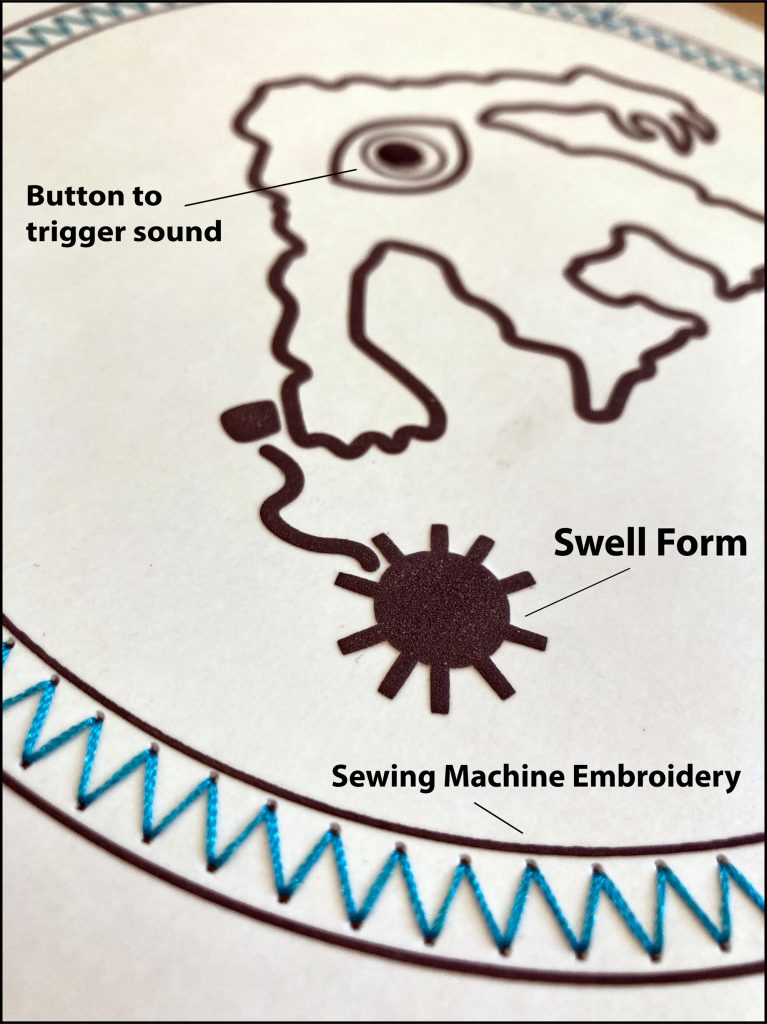 A closeup of a tactile graphic printed on microcapsule paper of the monster depicted in the Combat Information Center patch. The circular border around the monster is stitched in blue thread.